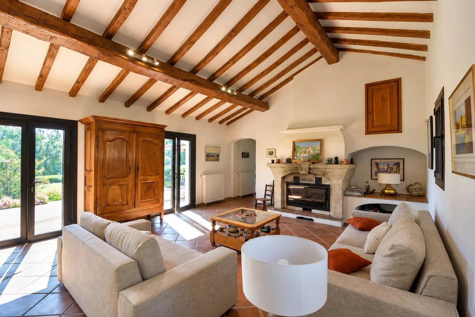 Living room of a property in Callian Interior of a property in Callian with a bright living room, exposed beams and a fireplace.