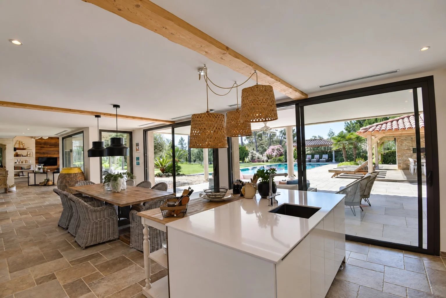 Interior of a luxury villa in Tourrettes Interior of a contemporary villa with open kitchen and dining room, overlooking the outdoor pool.