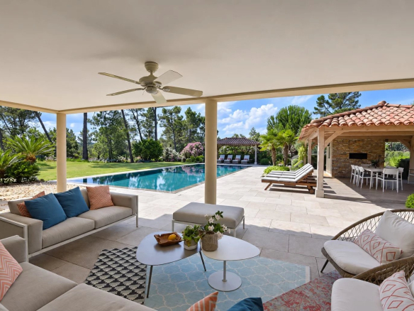 Terrace of a luxury villa with swimming pool, outdoor lounge and landscaped garden in Tourrettes.
