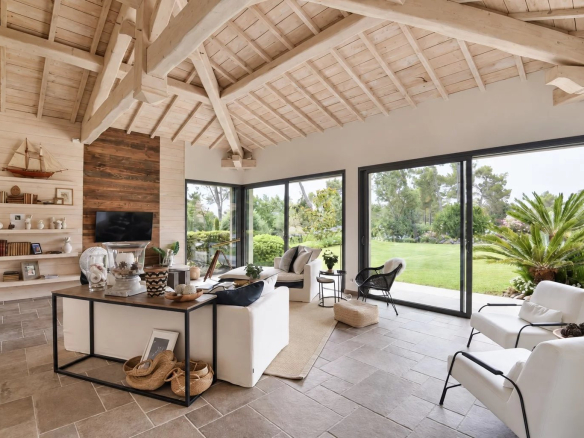 Interior of a contemporary villa with a bright living room and garden view.
