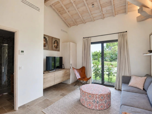 Interior of a contemporary villa with a bright living room and access to the outside.