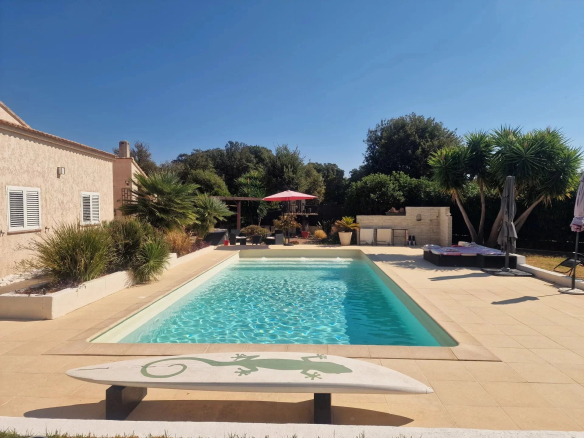 Villa with swimming pool in Marine de Solaro, Corsica, on landscaped grounds.