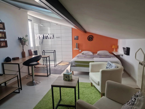 Modern room with double bed, sitting area and bathroom in Marine de Solaro, Corsica.