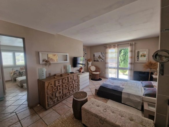 Room in a villa in Marine de Solaro, Corsica, with modern furniture and a window overlooking the outside.