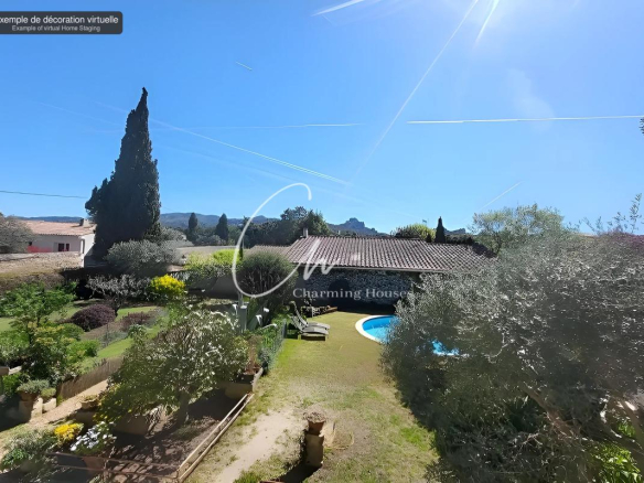 Sunlit backyard with a curved blue pool, a tiled-roof house, and a manicured garden of shrubs and trees under a bright blue sky with contrails.