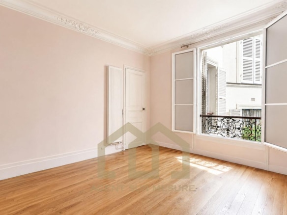 Intérieur d'un appartement vide avec fenêtres ouvertes et parquet au 5ème arrondissement de Paris.