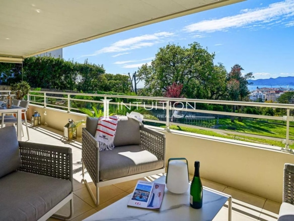 Terrace of an apartment in Cannes with sea view and garden furniture.