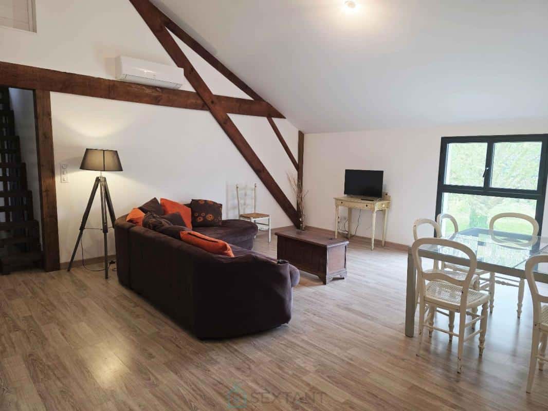 Interior of a property with living room, sofa, dining table and television.