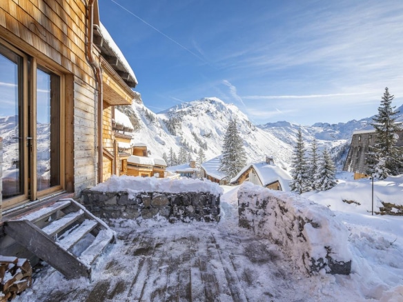Terrasse d'un chalet en bois avec vue sur les montagnes enneigées à Avoriaz.