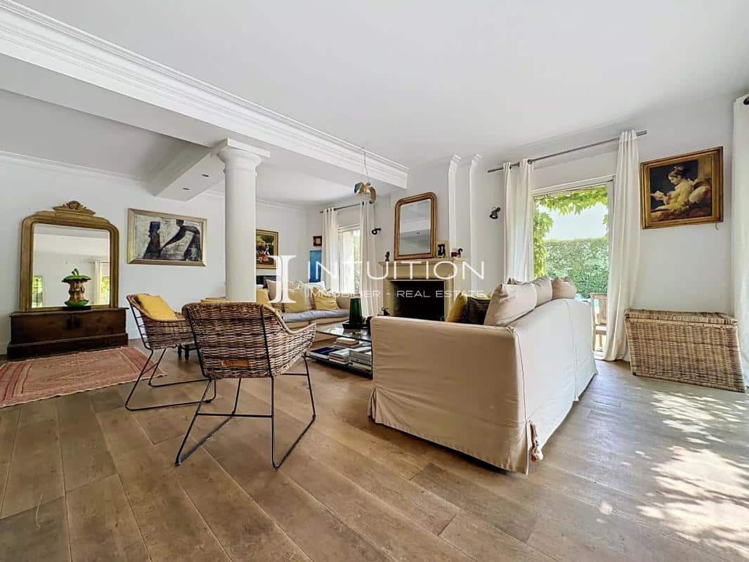 Interior of a Provençal villa in Mougins with a bright living room and fireplace.