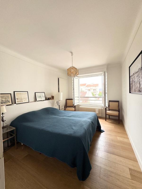 Room in an apartment in Biarritz with a bed, windows and simple decor.