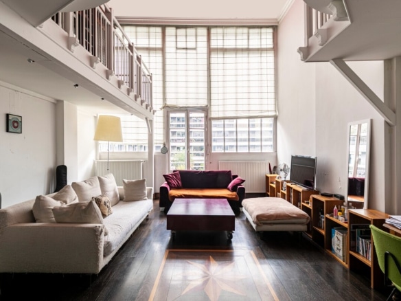 Interior of a bright artist's studio with a 5m ceiling, located near the Trocadero in Paris.