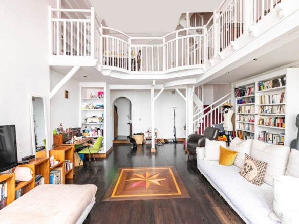 Interior of a bright and quiet 110 m2 triplex artist's studio with 5 m high ceilings.