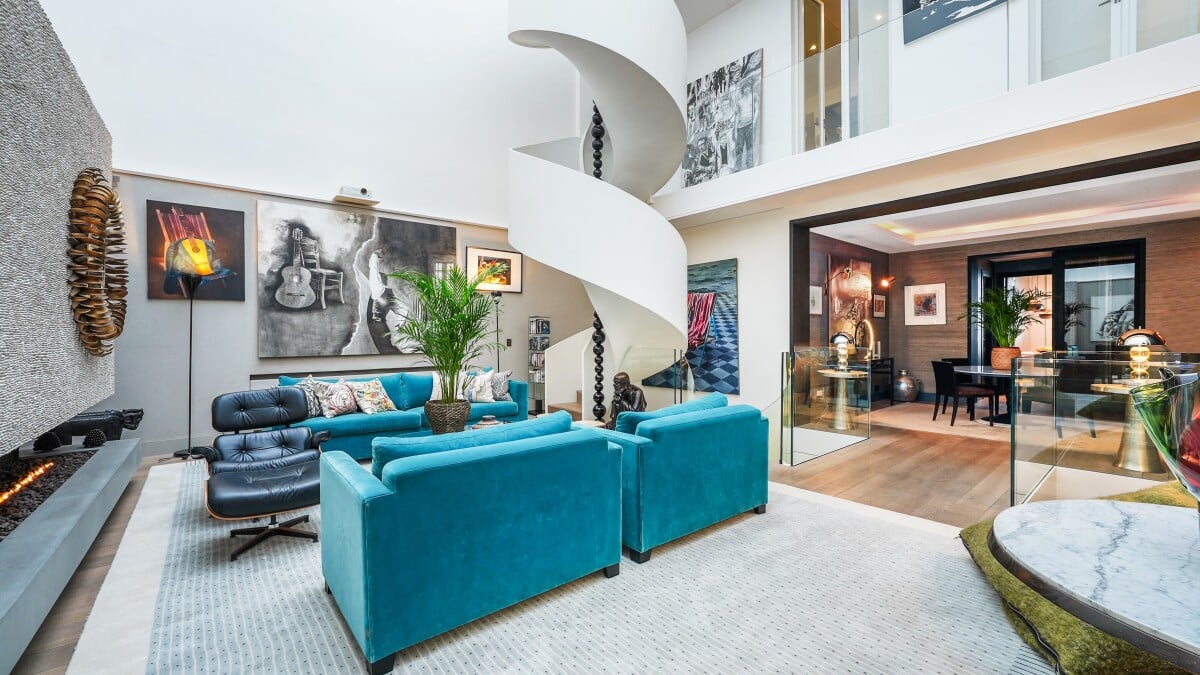Interior of a private mansion in Paris 7, with a modern living room and a spiral staircase.