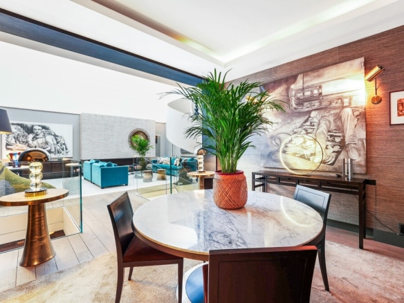 Interior of an elegant apartment with a marble table and plants, Paris 7th arrondissement.
