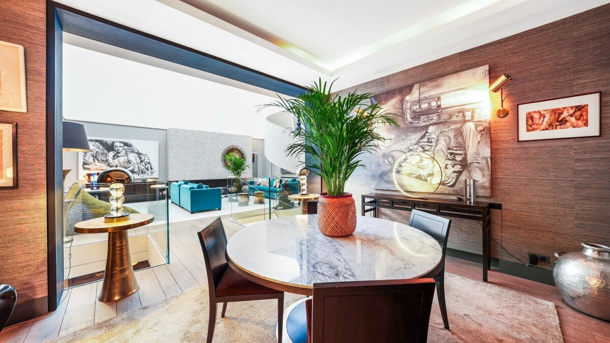 Interior of an elegant apartment with a marble table and plants, Paris 7th arrondissement.