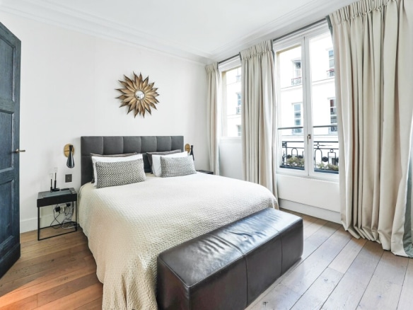 Room in a private mansion in Paris 7, with bed, windows and elegant decoration.