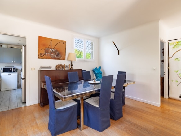 Interior of a house in La Celle-Saint-Cloud with a dining room and a visible kitchen.