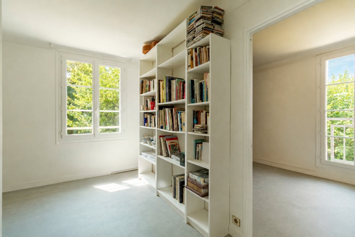 Interior of a house in La Celle-Saint-Cloud Interior of a house with shelves filled with books and windows letting in natural light.