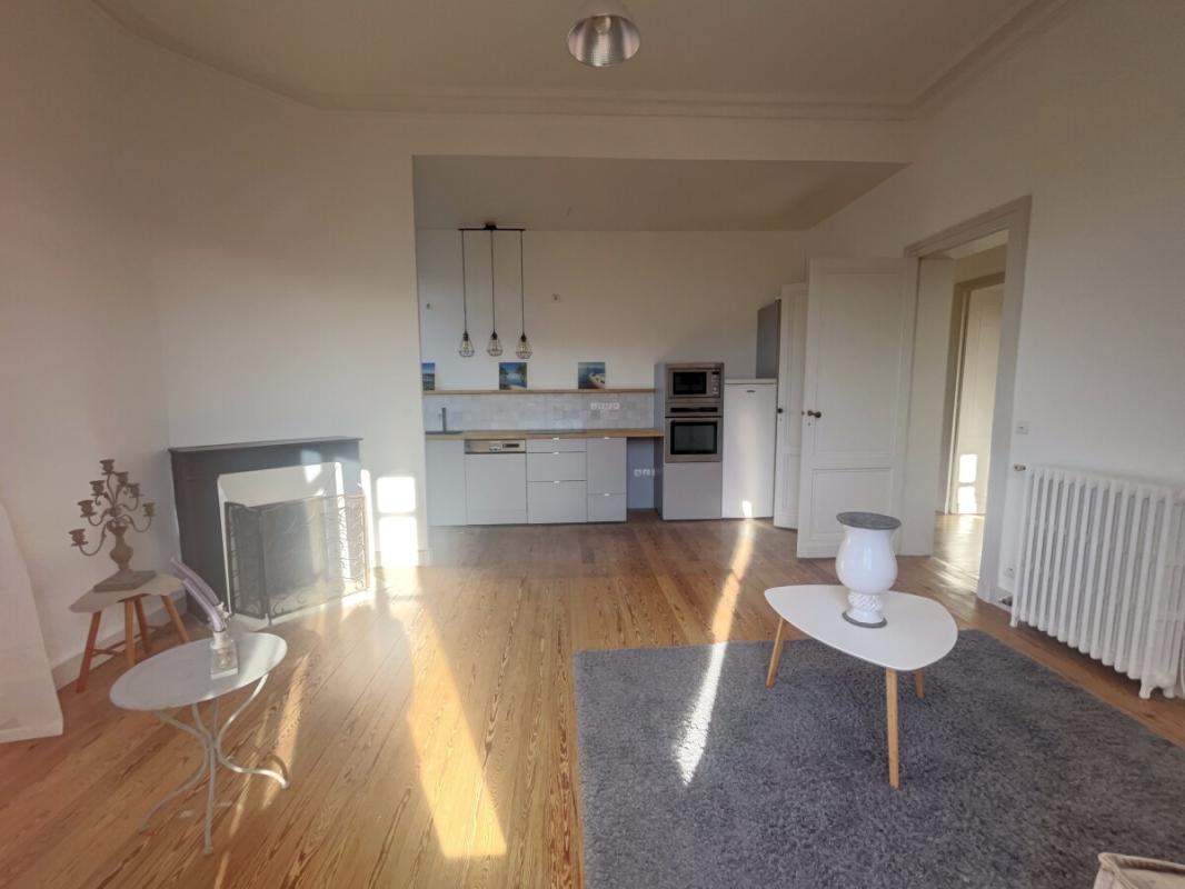 Renovated apartment in Arcachon Interior of a renovated apartment in Arcachon with a bright living room and open kitchen.