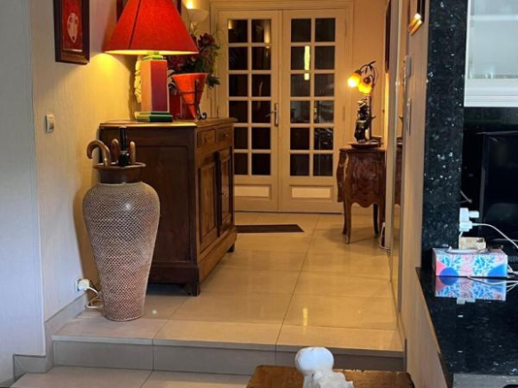 Interior of a house with a bright entrance hall and a wooden piece of furniture, Gattières.