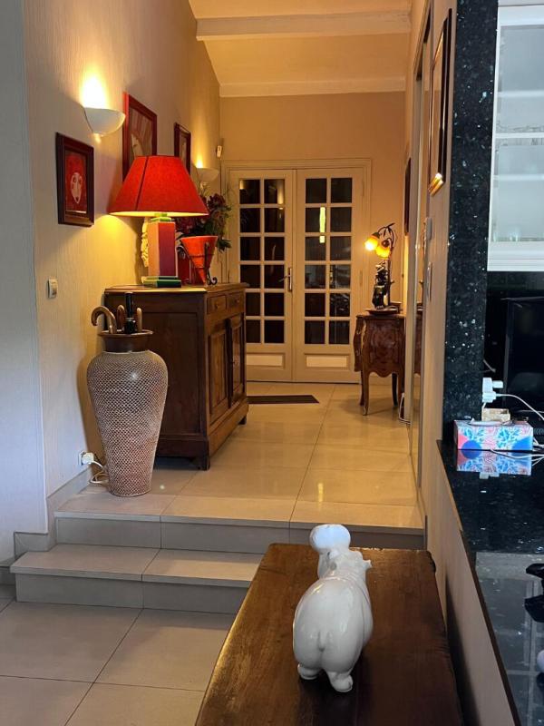 Interior of a house with a bright entrance hall and a wooden piece of furniture, Gattières.