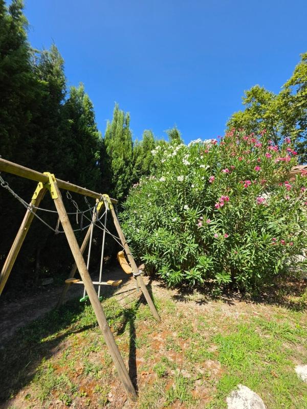 Garden with swing Play area with swing and plants in a quiet garden.