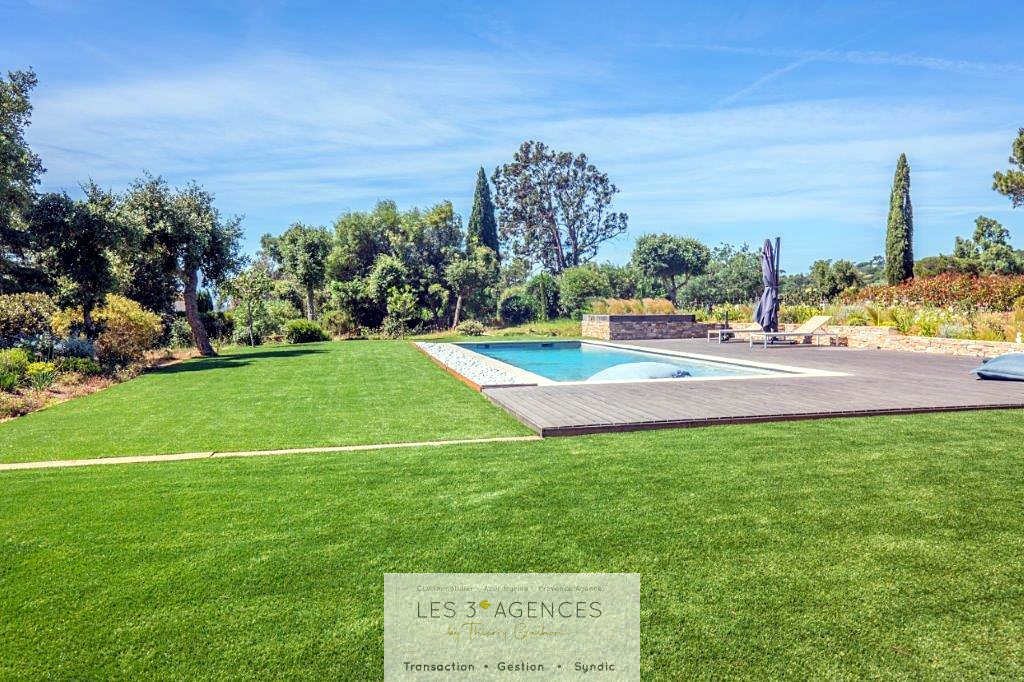 Garden and swimming pool of a villa in Grimaud View of a garden with swimming pool and lawn in a contemporary villa in Grimaud.