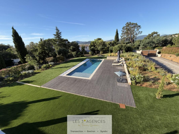 View of a contemporary villa with swimming pool and garden in Grimaud, France.
