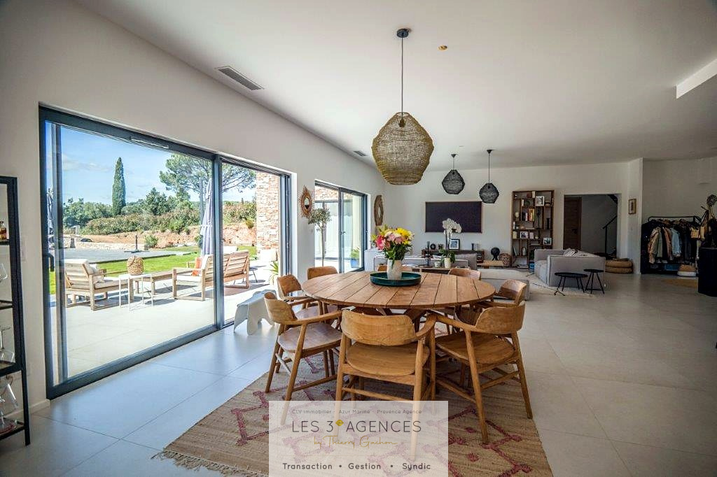 Contemporary villa in Grimaud Interior of a contemporary villa for sale in Grimaud, bright dining room with garden view.