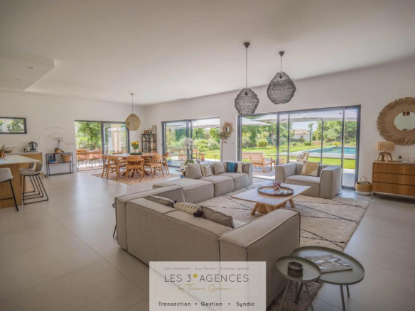 Interior of a contemporary villa in Grimaud with a spacious living room and garden view.