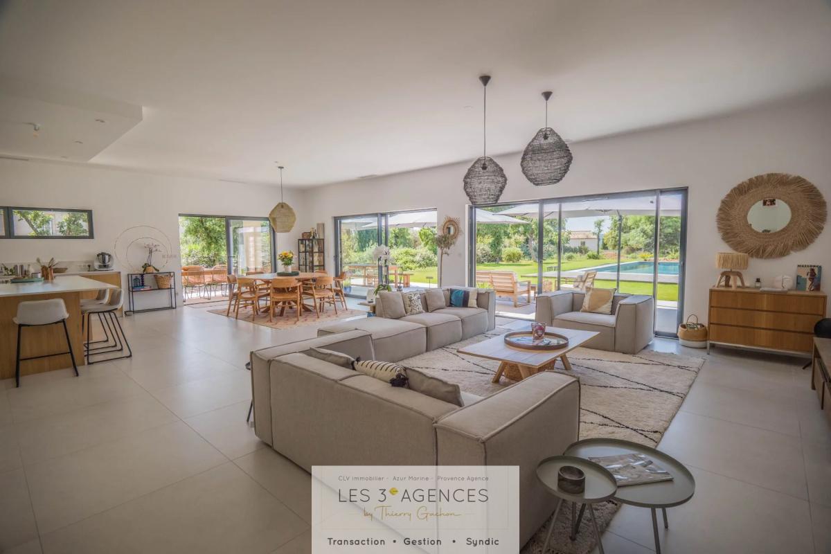Contemporary villa in Grimaud Interior of a contemporary villa in Grimaud with a spacious living room and garden view.
