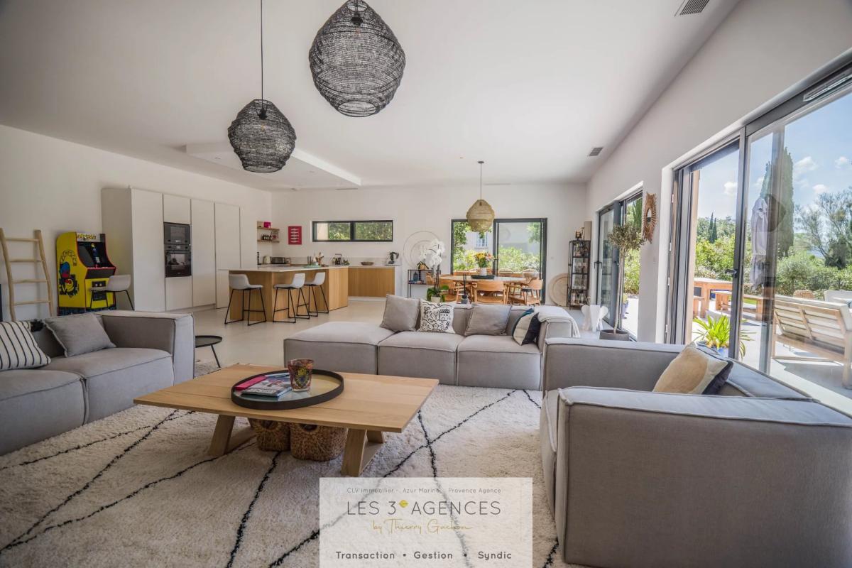 Living room of a villa in Grimaud Interior of a contemporary villa in Grimaud with a spacious living room and open kitchen.