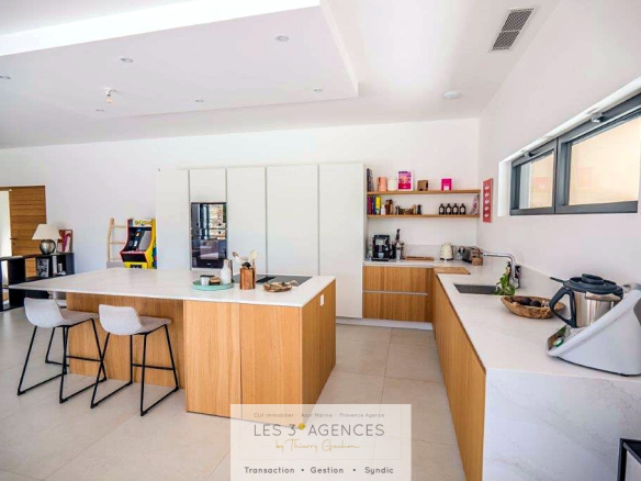 Interior of a contemporary villa in Grimaud with modern kitchen and bright living space.