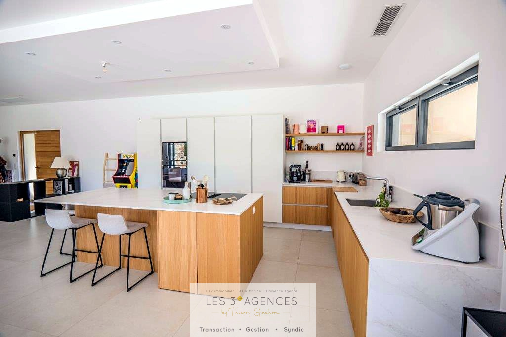 Modern kitchen in a villa in Grimaud Interior of a contemporary villa in Grimaud with modern kitchen and bright living space.