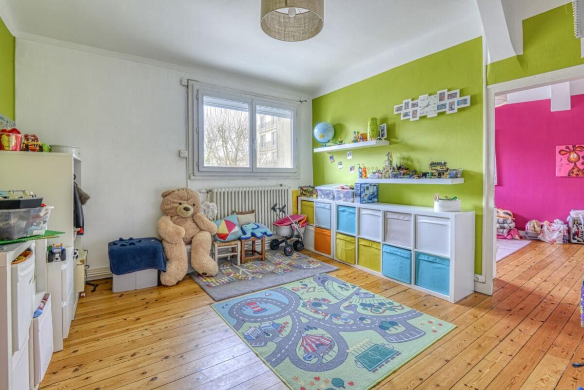Children's room Spacious children's room with green walls and toys, wooden parquet floor.
