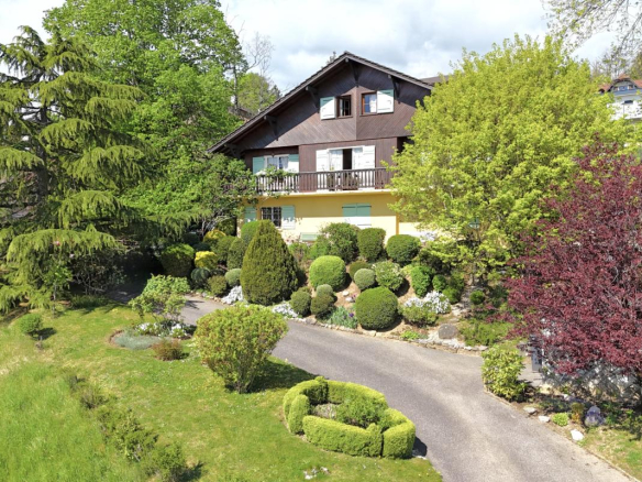 Large traditional chalet in Grilly with landscaped garden and views of the valley and Lake Geneva.