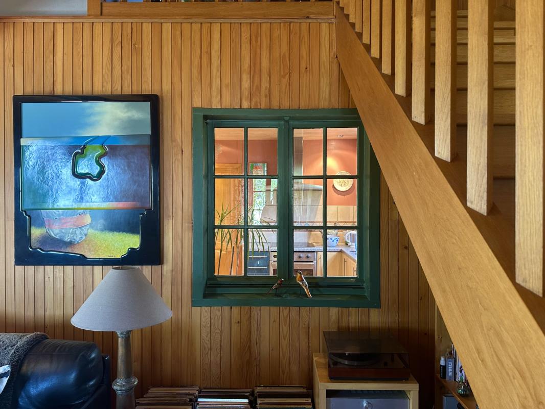 Interior of the chalet in Grilly Interior of a traditional chalet in Grilly with a wooden wall and a green window.