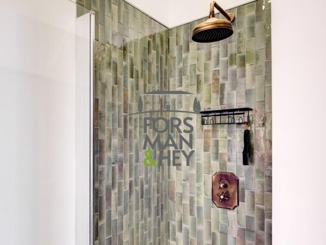 Contemporary shower Modern shower with green mosaic tiles and elegant faucets.