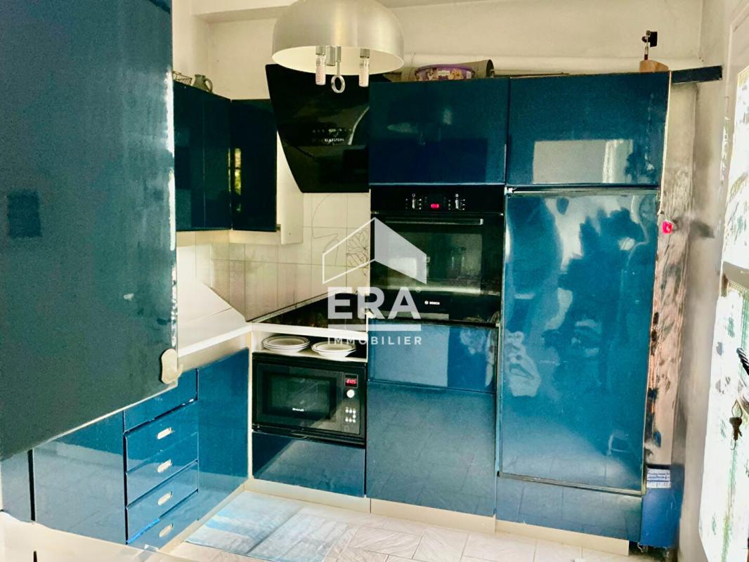 Kitchen of a house in La Gaude Modern kitchen with blue furniture and integrated appliances.