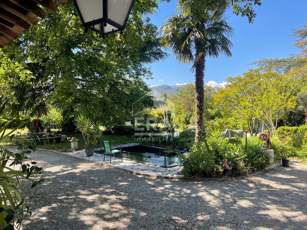 Exceptional House in La Gaude View of a house with garden and swimming pool, surrounded by trees, in La Gaude.