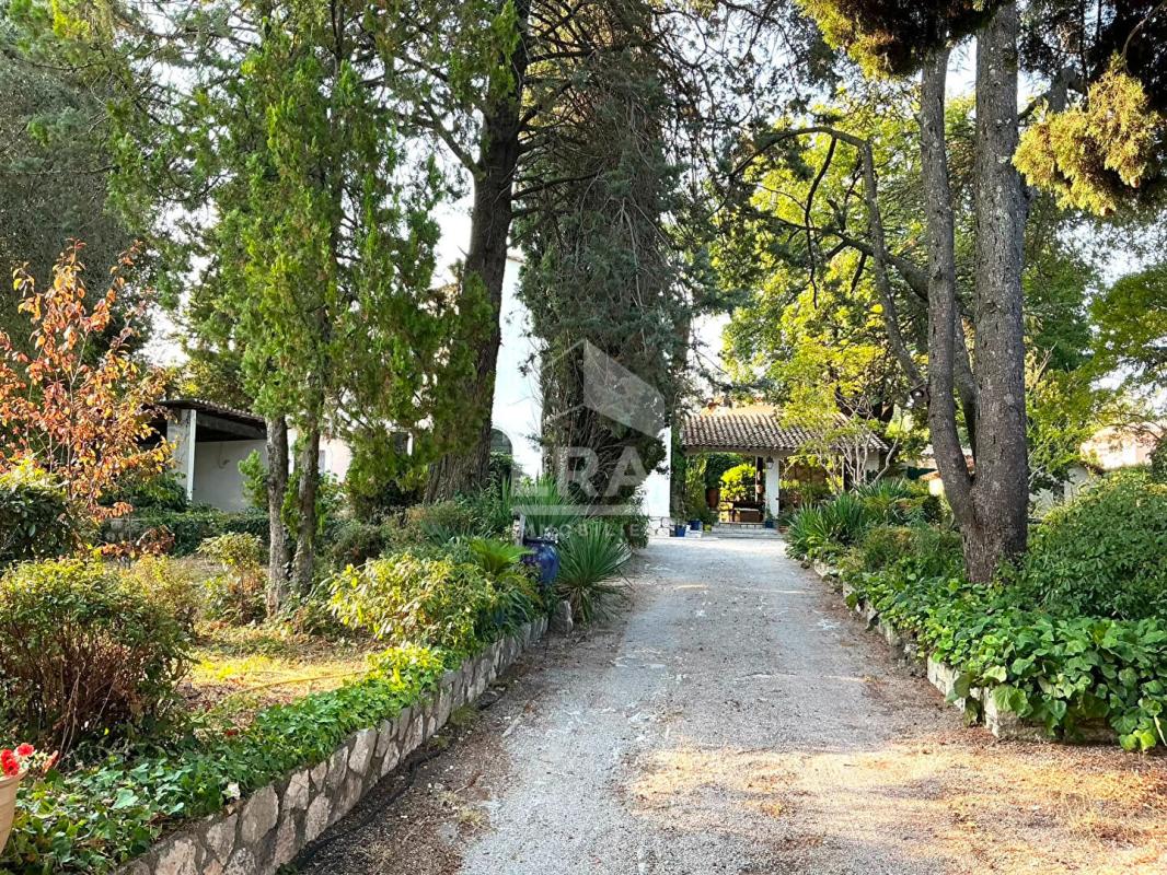 Exceptional House in La Gaude Driveway leading to a house surrounded by trees and greenery in La Gaude.