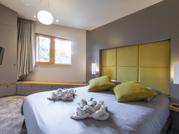 Chambre d'un chalet moderne avec lit double et décoration contemporaine à Morzine.