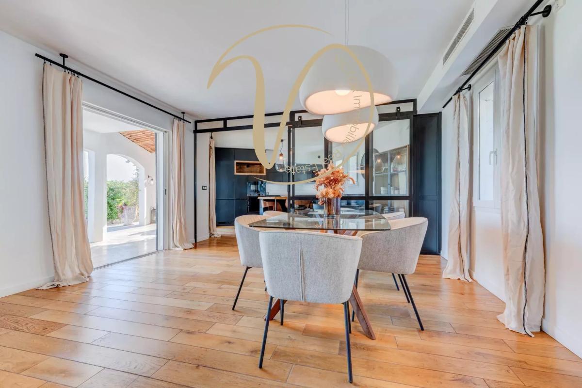 Contemporary dining room of the villa Interior of a modern villa with dining room and outdoor access, La Colle-sur-Loup.