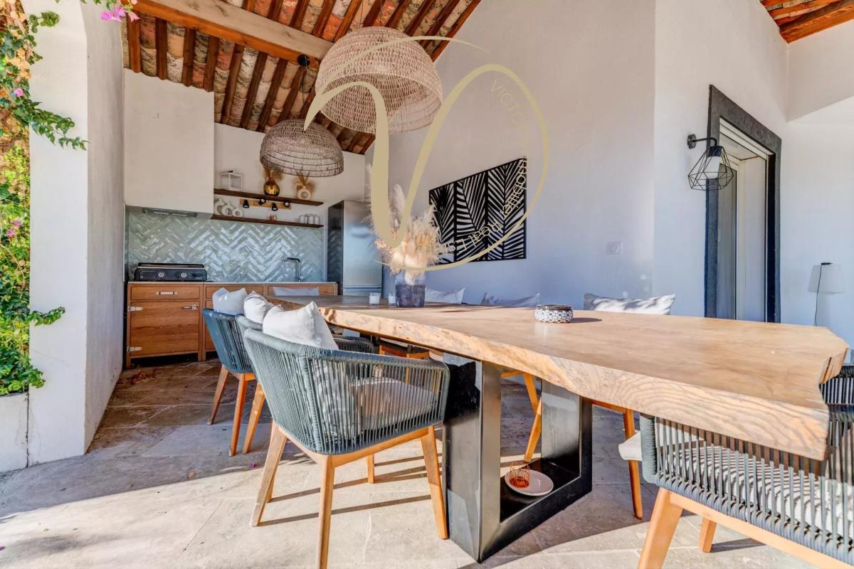 Interior of a contemporary villa Interior of a contemporary villa with a large wooden table and chairs, open kitchen.