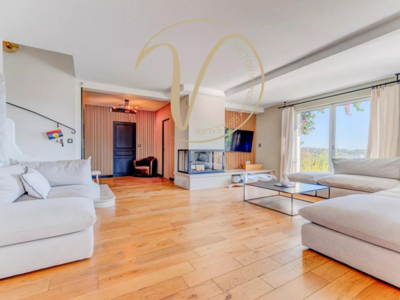 Interior of a contemporary villa in La Colle-sur-Loup with a spacious living room and fireplace.