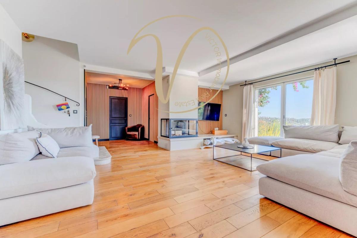 Interior of a contemporary villa in La Colle-sur-Loup Interior of a contemporary villa in La Colle-sur-Loup with a spacious living room and fireplace.