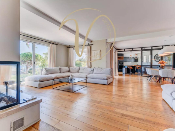 Interior of a contemporary villa with a spacious and bright living room, overlooking the sea.