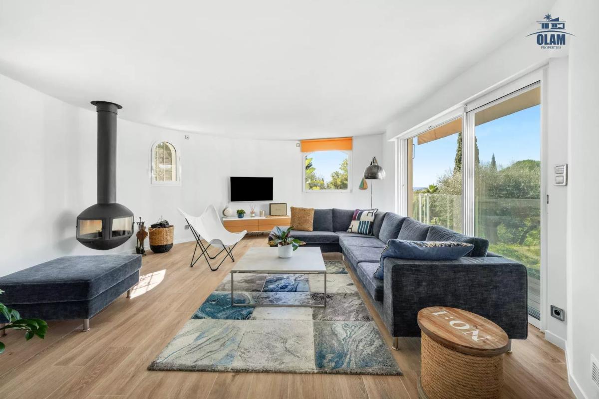 Intérieur d'une villa moderne à Cannes avec salon lumineux et cheminée.