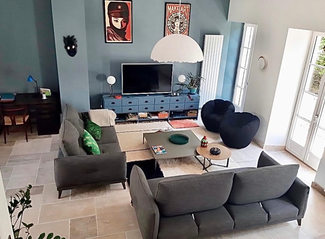 Intérieur d'un salon spacieux et lumineux avec des canapés modernes et une décoration contemporaine.